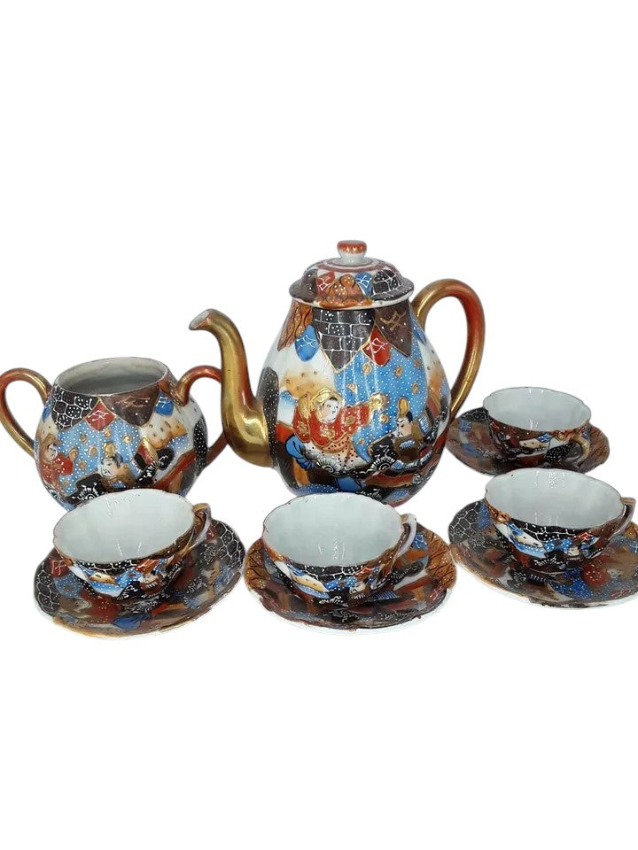 Antique Japanese hand-painted porcelain coffee set with coffee pot, sugar pot, cups, and saucers, richly decorated with figures and gilded detail.