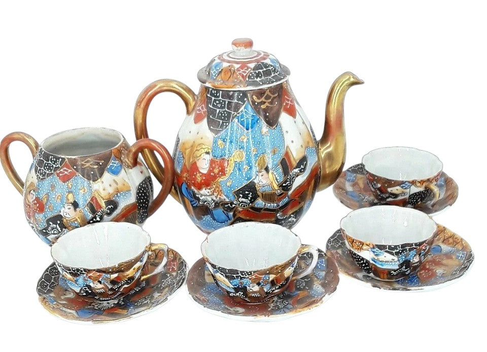 Antique Japanese hand-painted porcelain coffee set with coffee pot, sugar pot, cups, and saucers, richly decorated with figures and gilded detail.