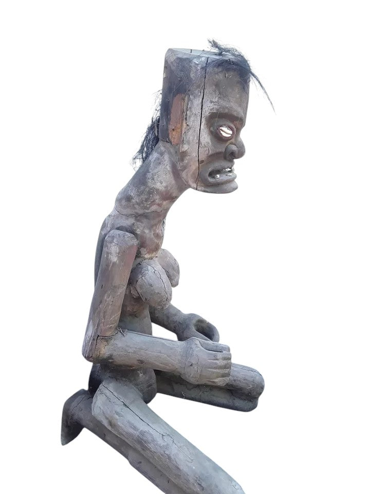 Pair of African 20th century carved wood figures with exaggerated features, shell eyes, and natural hair, male and female, in aged condition.
