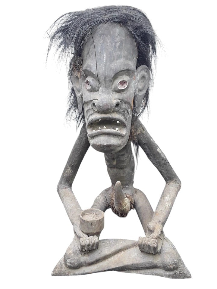Pair of African 20th century carved wood figures with exaggerated features, shell eyes, and natural hair, male and female, in aged condition.