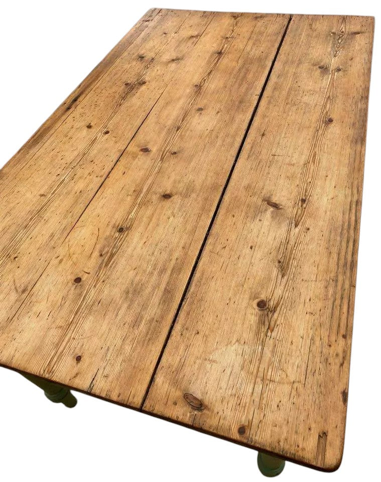 Top view of rustic pine plank dining table with natural oiled finish.