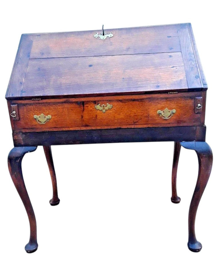 Antique Georgian oak fall-front bureau on cabriole legs with fitted interior, small drawers, and pad feet, circa 18th century.