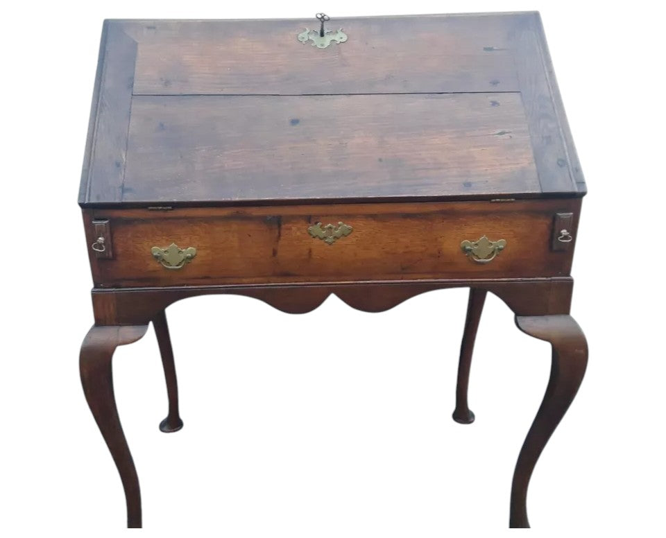 Antique Georgian oak fall-front bureau on cabriole legs with fitted interior, small drawers, and pad feet, circa 18th century.