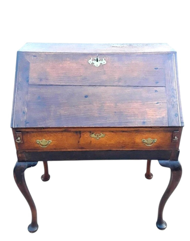 Antique Georgian oak fall-front bureau on cabriole legs with fitted interior, small drawers, and pad feet, circa 18th century.