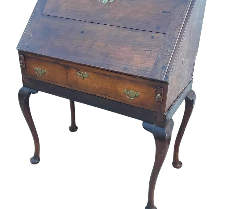 Antique Georgian oak fall-front bureau on cabriole legs with fitted interior, small drawers, and pad feet, circa 18th century.