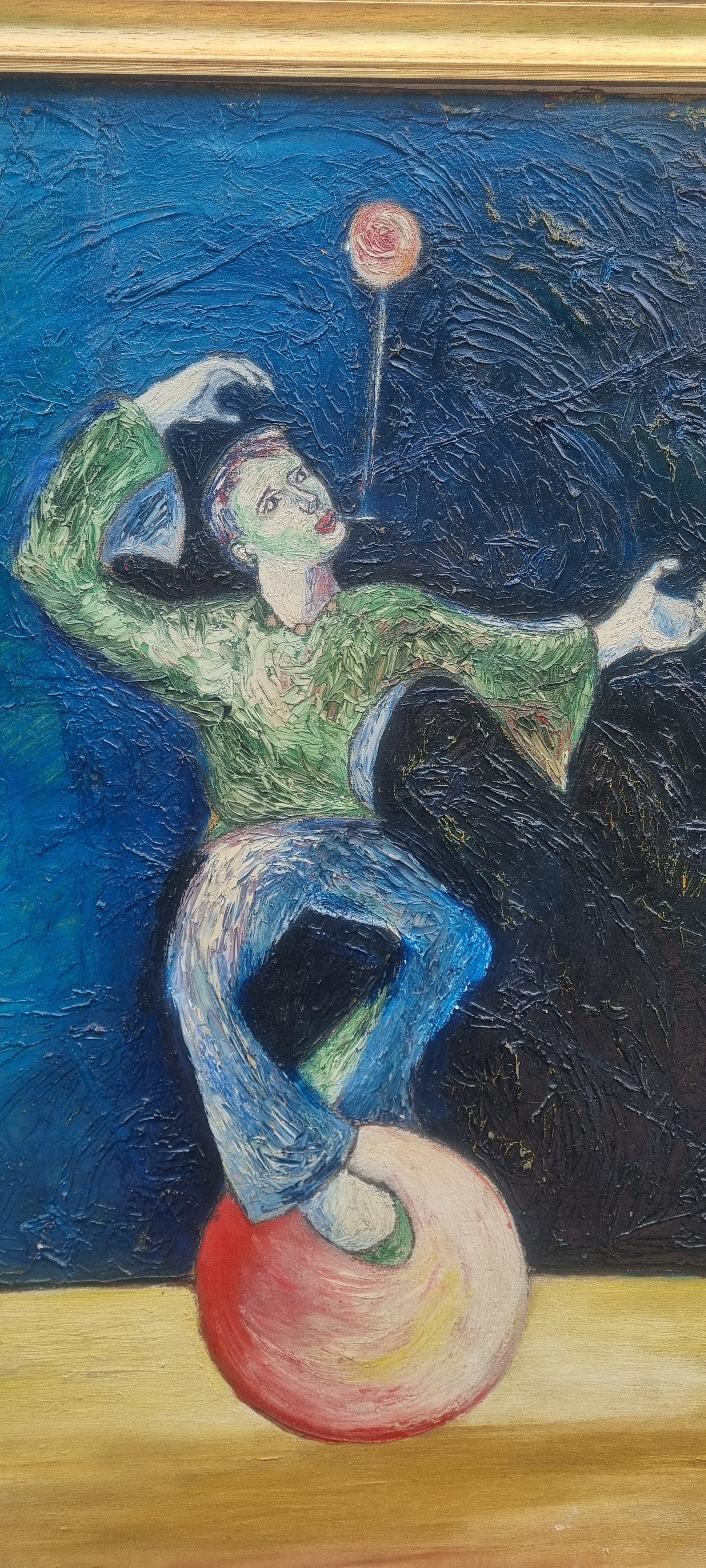 Framed oil painting of a unicyclist performer signed Peter Arnold, with bold brushstrokes and vibrant blue background.