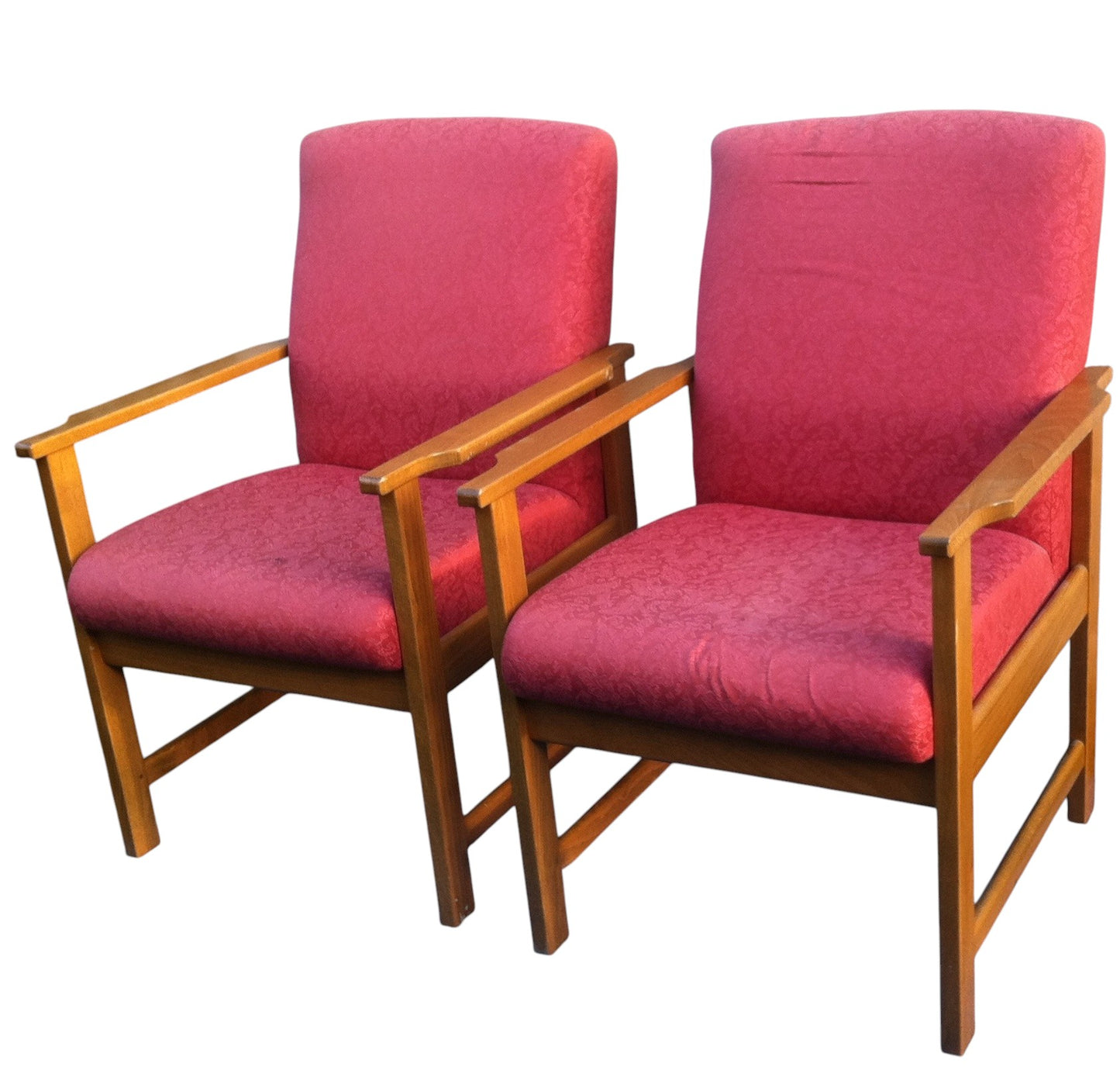Two red chairs with wooden frames on a white background