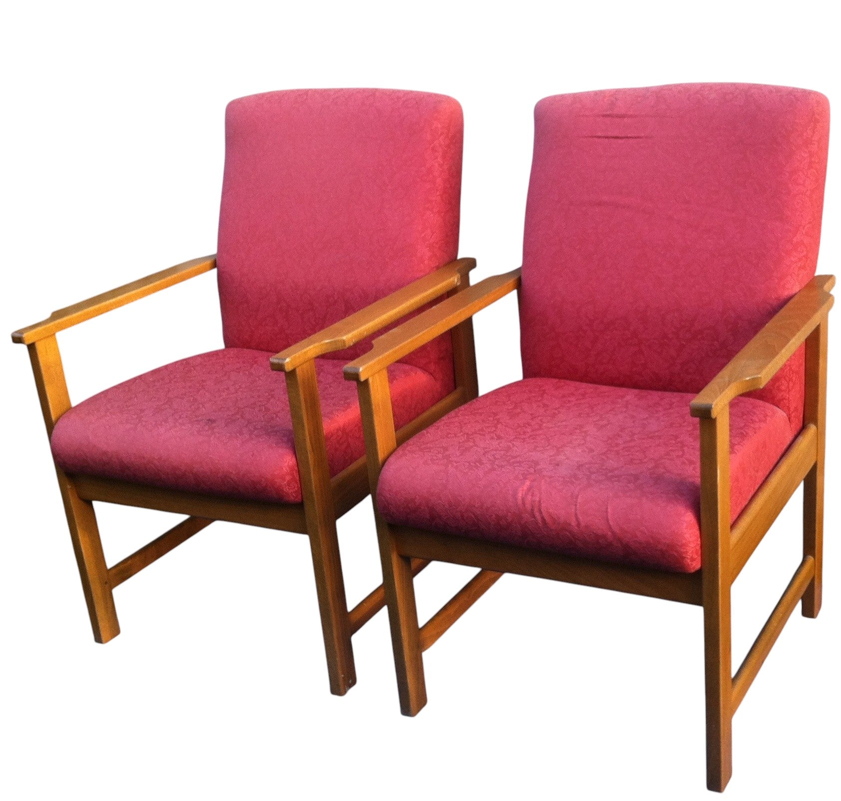 Two red chairs with wooden frames on a white background