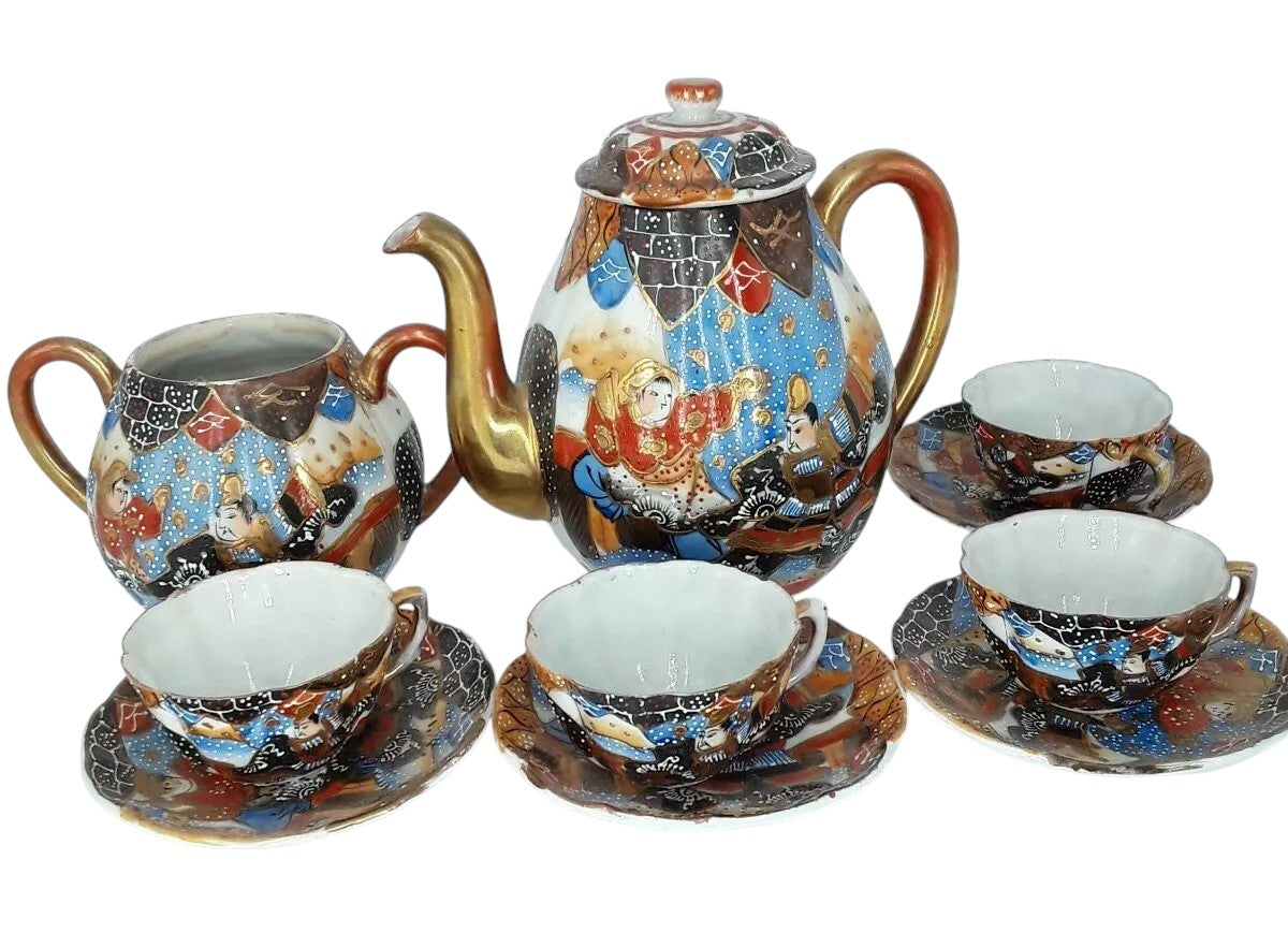 Antique Japanese hand-painted porcelain coffee set with coffee pot, sugar pot, cups, and saucers, richly decorated with figures and gilded detail.