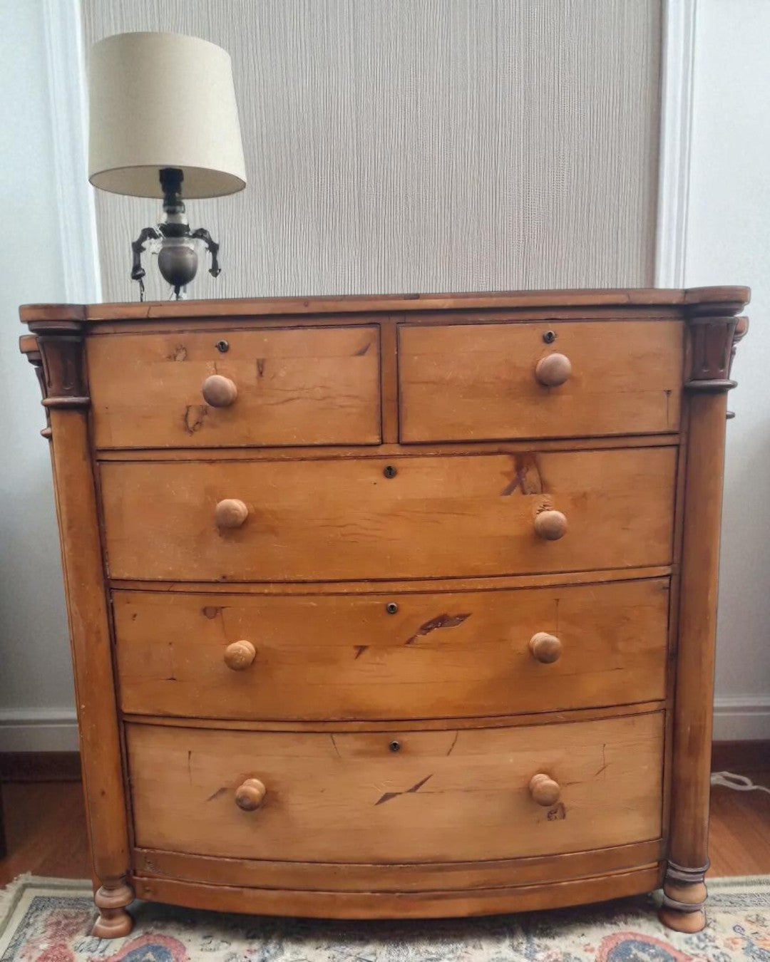 Victorian solid pine bow-front chest of drawers with elegant rustic patina and ample storage.