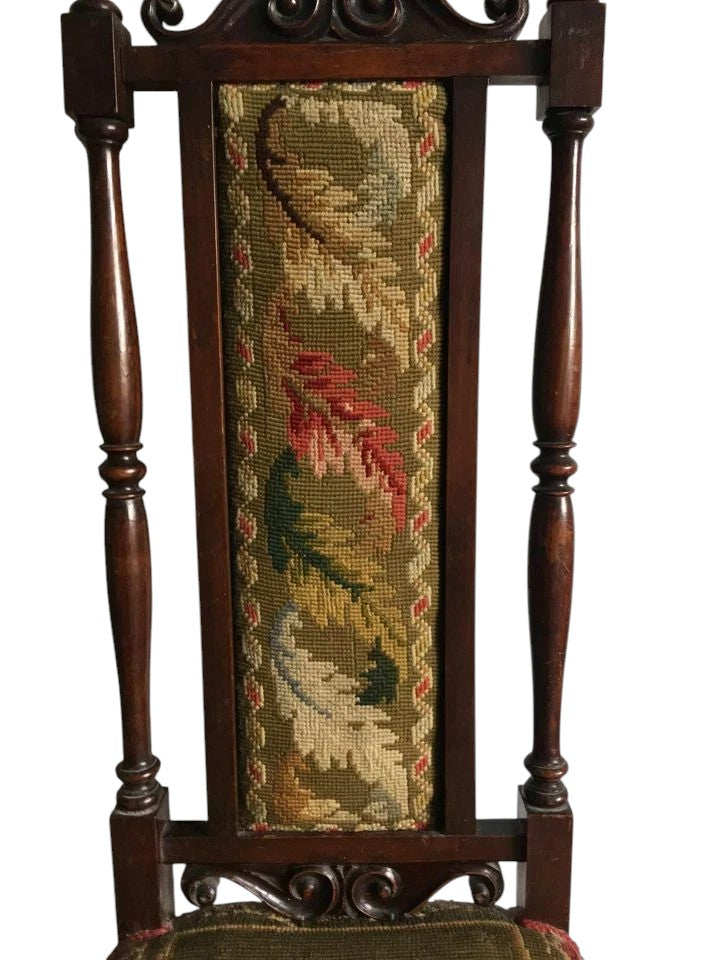 Side view of Victorian prayer chairs showing carved oak detail.