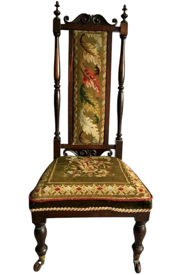 Close-up of antique Victorian chair tapestry with floral motifs.