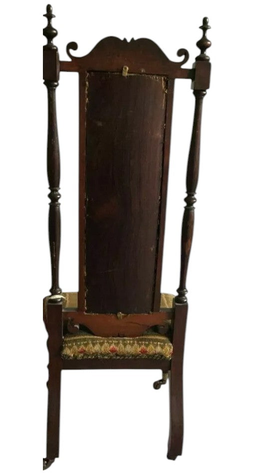 Vintage wooden chair with a tall backrest on a white background