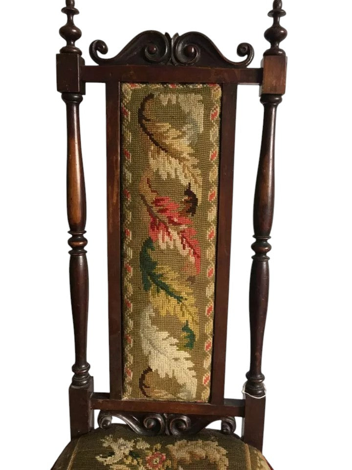 Close-up of antique Victorian chair tapestry with floral motifs.