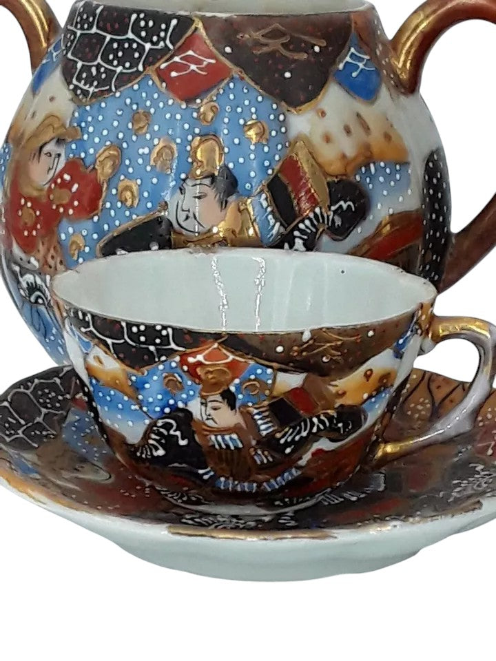 Antique Japanese hand-painted porcelain coffee set with coffee pot, sugar pot, cups, and saucers, richly decorated with figures and gilded detail.
