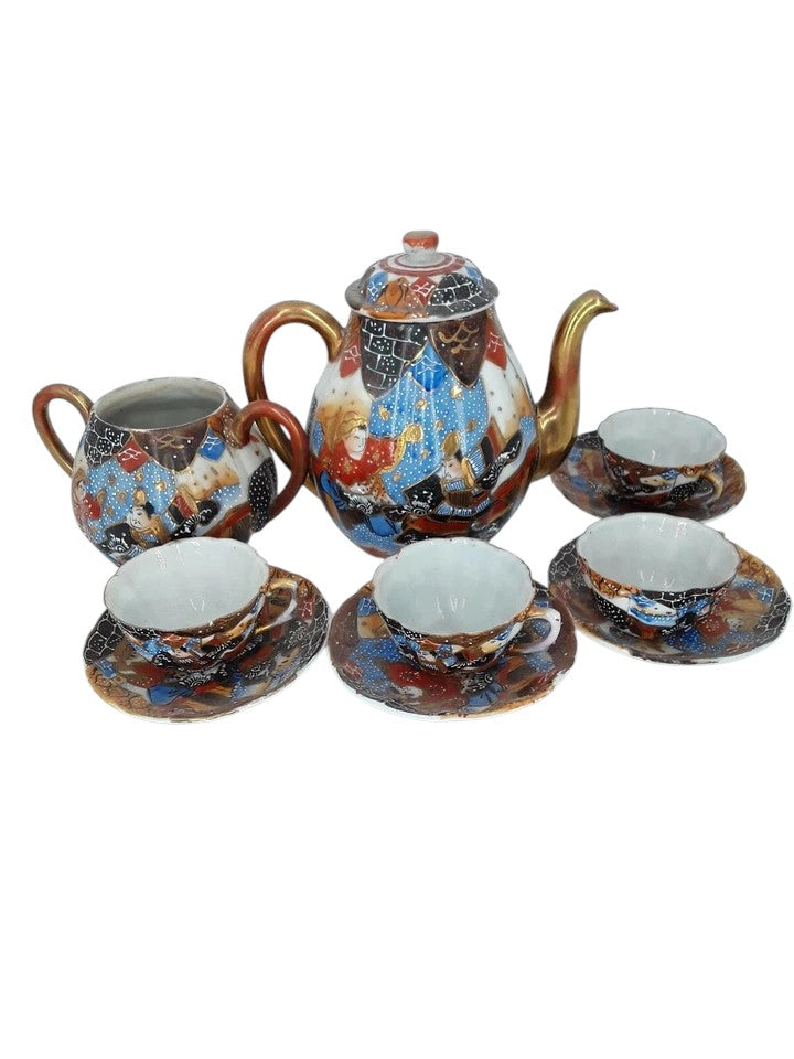 Antique Japanese hand-painted porcelain coffee set with coffee pot, sugar pot, cups, and saucers, richly decorated with figures and gilded detail.