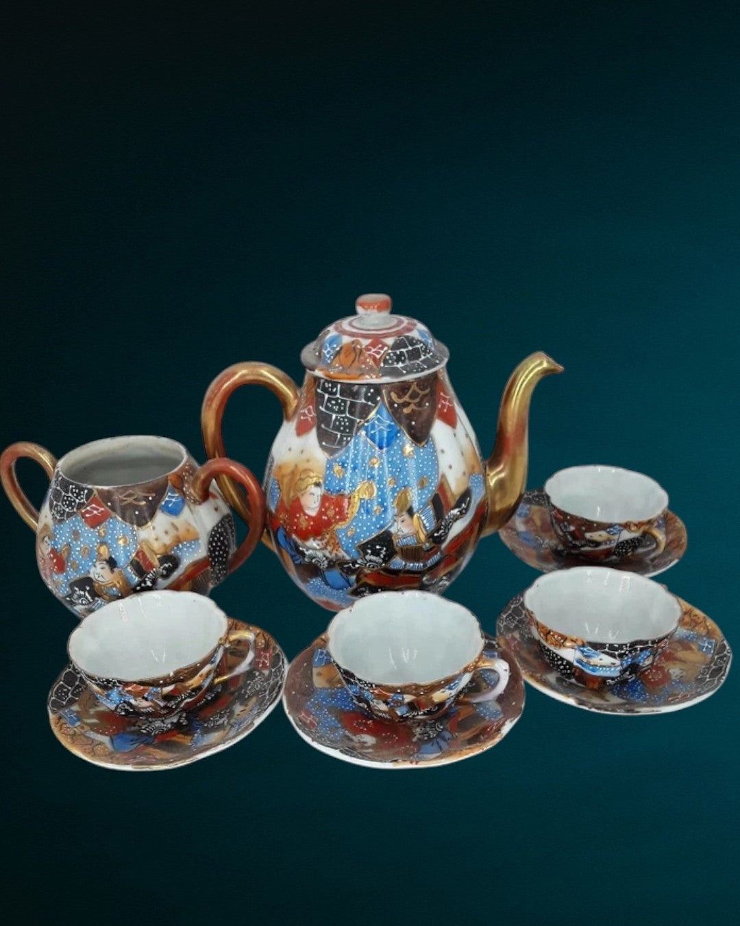Antique Japanese hand-painted porcelain coffee set with coffee pot, sugar pot, cups, and saucers, richly decorated with figures and gilded detail.