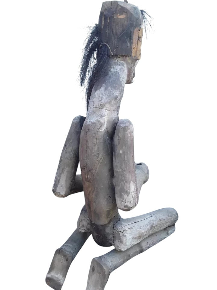 Pair of African 20th century carved wood figures with exaggerated features, shell eyes, and natural hair, male and female, in aged condition.