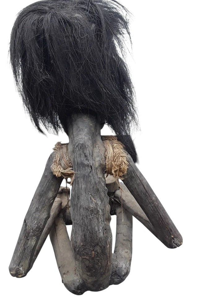 Pair of African 20th century carved wood figures with exaggerated features, shell eyes, and natural hair, male and female, in aged condition.