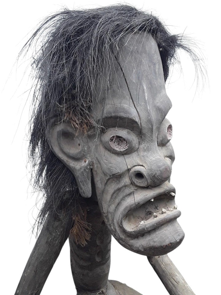 Pair of African 20th century carved wood figures with exaggerated features, shell eyes, and natural hair, male and female, in aged condition.