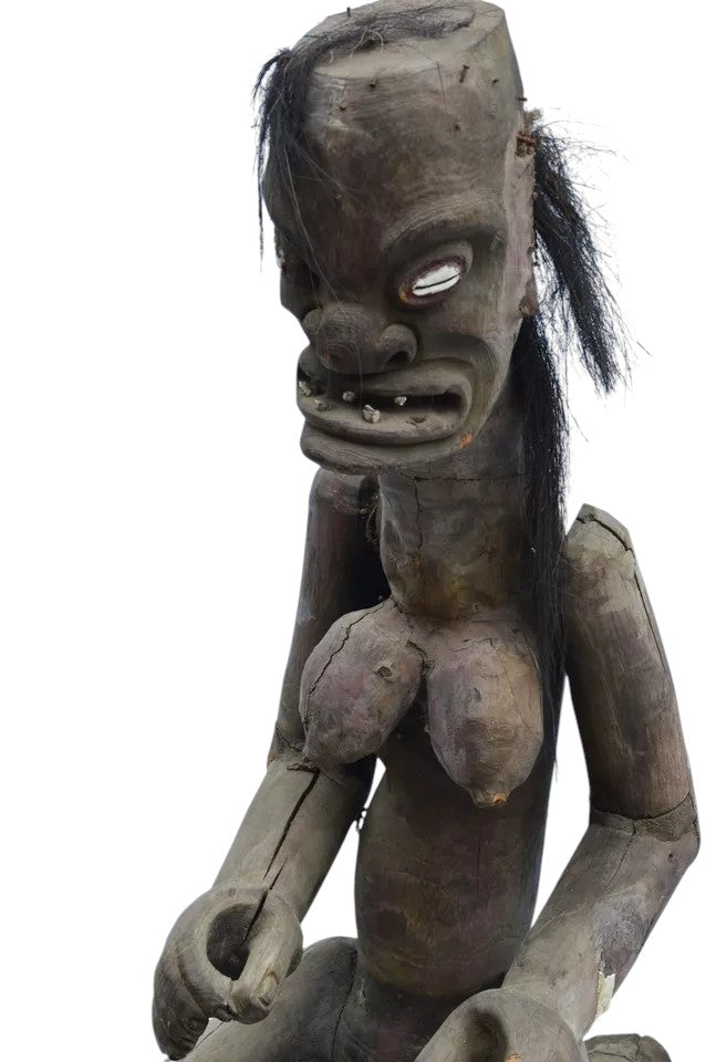 Pair of African 20th century carved wood figures with exaggerated features, shell eyes, and natural hair, male and female, in aged condition.