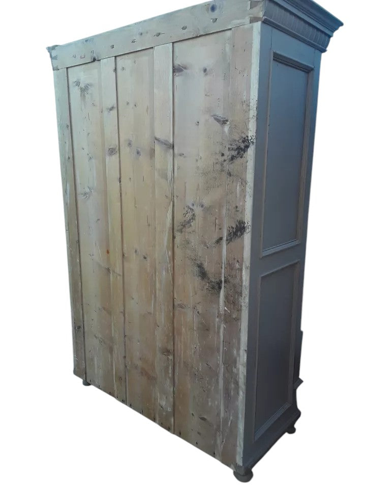 Antique pine wardrobe with two panelled doors, original lock, and large base drawer with iron handles, rustic farmhouse style.